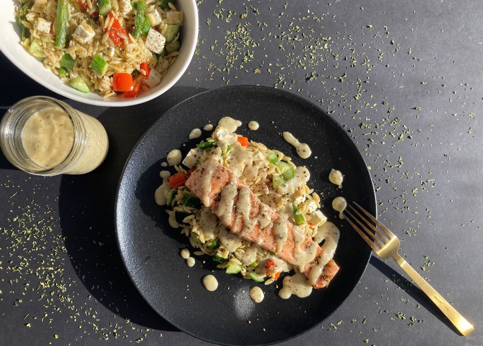 RECIPE: Grilled salmon with creamy garlic sauce served on warm orzo salad