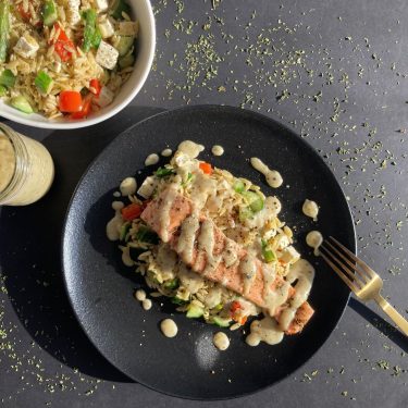 RECIPE: Grilled salmon with creamy garlic sauce served on warm orzo salad